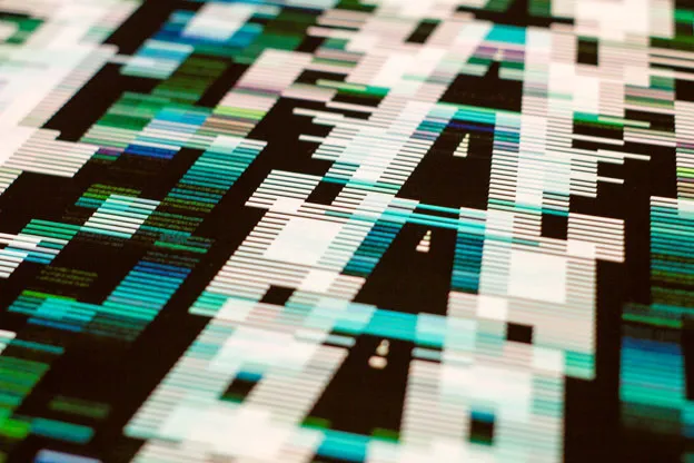 Angled close-up of a print's white, green, and cyan horizontal lines on black.