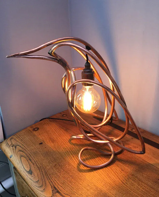 The lit lamp facing left on the same wooden chest.